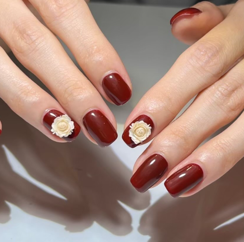 Burgundy nails with white 3D rose details