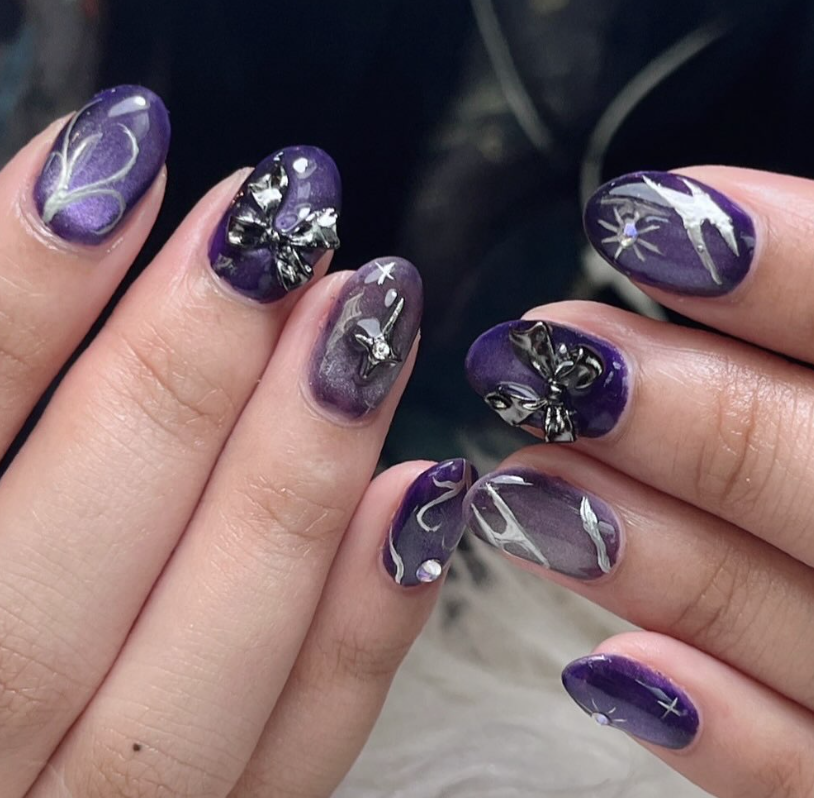 Purple chrome nails with butterfly charms